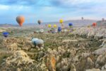 photo of assorted-color air balloon lot in mid air during daytime in Turkey