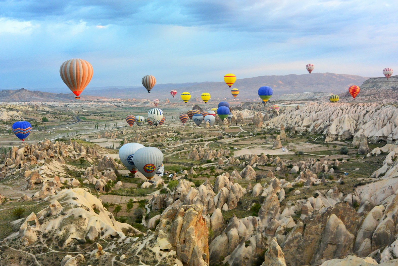 photo of assorted-color air balloon lot in mid air during daytime in Turkey