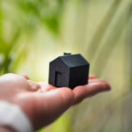 Energy-efficient ClassGreen Property Investing. A house with solar panels on its roof, a symbol of successful green investing in property.