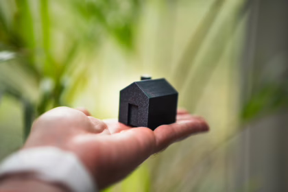 Energy-efficient ClassGreen Property Investing. A house with solar panels on its roof, a symbol of successful green investing in property.